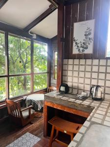 a kitchen with a counter and a bed in a room at Mocha Latte Homestay & Cafe in Chiang Rai