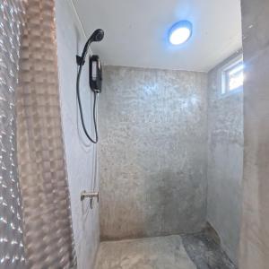 a shower with a phone on the wall in a bathroom at Mocha Latte Homestay & Cafe in Chiang Rai +36 photos