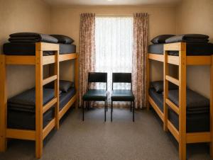two bunk beds in a room with a window at Shady Acres Caravan Park in Warrenheip