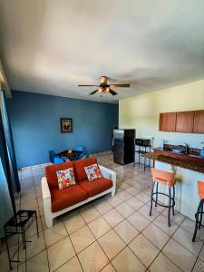 a living room with a couch and a kitchen at Sueños del Mar in Fajardo +22 photos