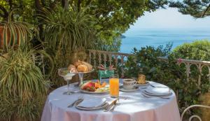 a table with a plate of food and a bowl of fruit at Romantic Hotel & Restaurant Villa Cheta Elite in Maratea