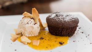 a chocolate cupcake and ice cream on a plate at Romantic Hotel & Restaurant Villa Cheta Elite in Maratea