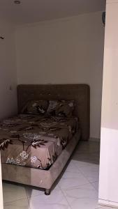 a bed sitting in a room with a bed frame at Mdiaq in M'diq