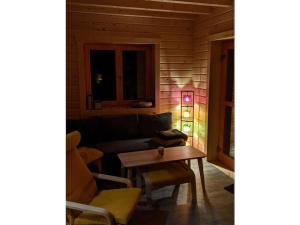 a living room with a couch and a table at Forest park at Roofensee in Stechlin +9 photos