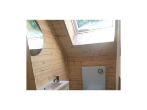 a bathroom with a toilet and a window at Forest park at Roofensee in Stechlin