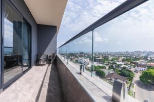 an apartment balcony with a view of the city at FLORIA - Sky Suites in Accra