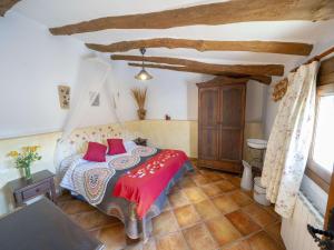 a bedroom with a bed with red pillows at 4-Guest Laroya Cottage with Pool in Laroya