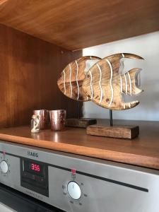 a fish sculpture sitting on top of a microwave at Aeria Elegant Luxury Villa in Asprovalta