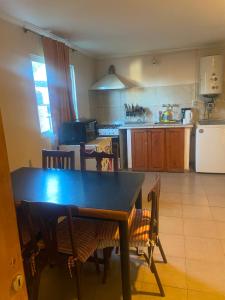 a kitchen with a table and chairs and a table and a kitchen at Depto Candioti excelente ubicación Aire Calefacción Wifi in Santa Fe