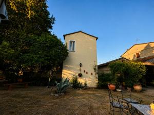 a white building with a window on the side of it at La Casetta in San Terenziano