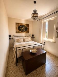 a bedroom with a large bed and a table at La Casetta in San Terenziano