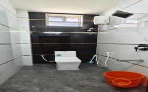 a small bathroom with a toilet and a window at S R RESORTS in Chīrāla +31 photos