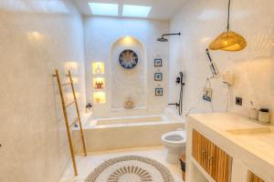 a bathroom with a tub and a toilet and a sink at Villa Calipso in Gili Trawangan +13 photos