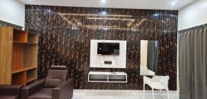 a bathroom with a wall covered in gold sequins at S R RESORTS in Chīrāla