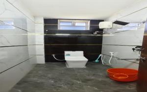 a small bathroom with a toilet and a window at S R RESORTS in Chīrāla
