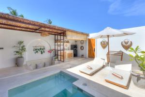 a villa with a swimming pool and a patio at Villa Afrodite in Gili Trawangan +10 photos