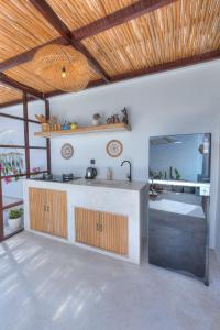 a kitchen with a counter and a sink in a room at Villa Afrodite in Gili Trawangan
