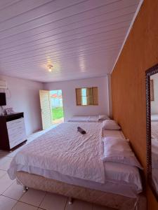 a bedroom with a large white bed with a window at Pousada Villa Cerrado in Caldas Novas +19 photos