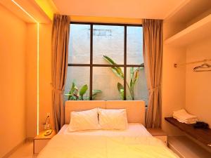 a bedroom with a bed and a large window at Villa Pii-House in Ấp Sung Xuân +18 photos