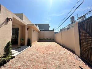 a brick walkway in front of a house at Villa Pii-House in Ấp Sung Xuân