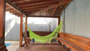 a hammock on the porch of a house at Recanto Veraneio in Londrina