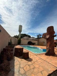 a swimming pool with logs and a pool at Pousada Villa Cerrado in Caldas Novas