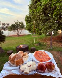 a table with bread and other foods on it at Pousada Villa Cerrado in Caldas Novas