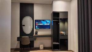 a room with a desk with a mirror and a computer at LION 7 HOTEL in Can Tho +19 photos
