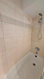 a white bath tub in a bathroom with a shower at Bright & Cozy Garden Level Suite in North Vancouver +4 photos
