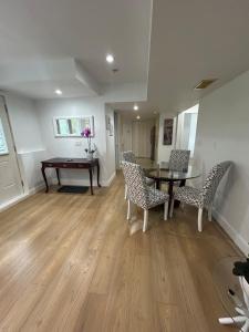 an empty living room with a table and chairs at Bright & Cozy Garden Level Suite in North Vancouver
