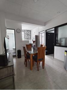 a kitchen and dining room with a table and chairs at Bahamas House in Ibagué