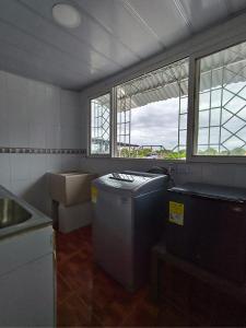 a kitchen with a sink and windows in a room at Bahamas House in Ibagué