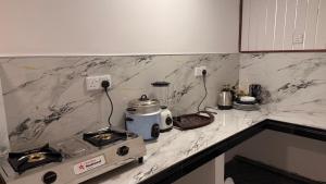 a kitchen counter with a stove and a appliance on it at Arcadia villas Arugambay in Arugam Bay +75 photos