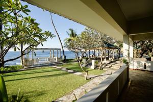 a view of the ocean from a house at Poinciana Resort in Tejakula