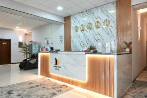 a lobby with a reception desk with a marble wall at Amor fati hotel Tashkent in Katartal