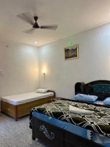 a bedroom with a bed and a ceiling fan at The quiet corner homestay in Rudraprayāg