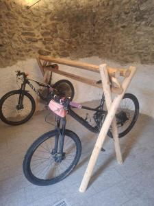 a bike is parked next to a wooden table at Appartamenti il bersaio Alloggio 3 in Sambuco