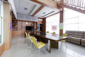a conference room with a wooden table and yellow chairs at RedDoorz Premium @ Ampera Raya 2 in Jakarta