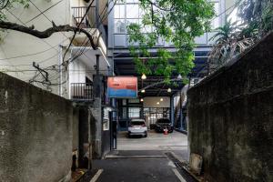 an alley with a car parked in a building at RedDoorz Premium @ Ampera Raya 2 in Jakarta