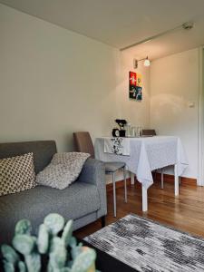 a living room with a couch and a table at Systrarna på Kivik in Kivik