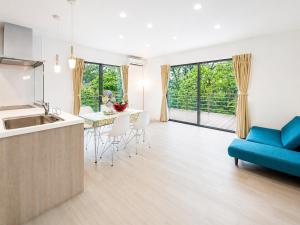 a kitchen and living room with a blue couch at Knot in Shodoshima