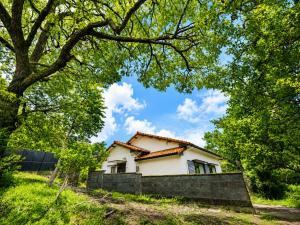 a white house behind a stone wall at Knot in Shodoshima