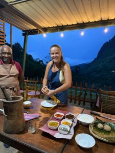a woman standing in front of a table with food at Ella Rock Heaven in Ella +62 photos