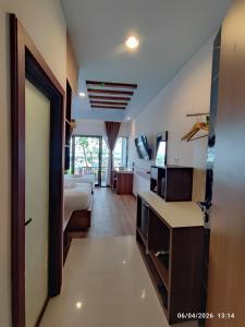 a hotel room with a bedroom and a bed at Wisma SIDAPORE JD in Lamobuang +7 photos