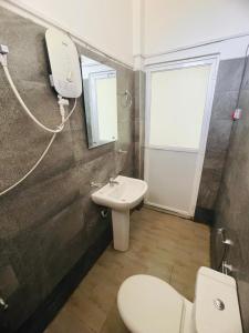 a bathroom with a toilet and a sink at Relax Cottage in Mailagamuwa