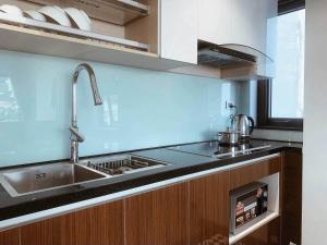 a kitchen with a stainless steel sink and a stove at Ronaldo Palacios in Pagadian