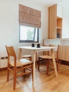 a kitchen with a table and chairs and a window at Ronaldo Palacios in Pagadian