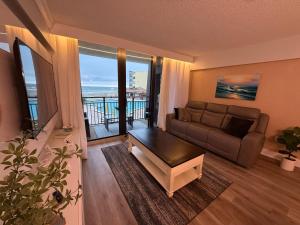 a living room with a couch and a table at Ocean View Condo in Daytona Beach