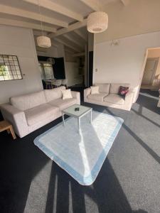 a living room with two couches and a coffee table at The Summer House in Mangonui