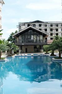 a large swimming pool in front of a building at Airport Gem with Pool and Gym in Pusok